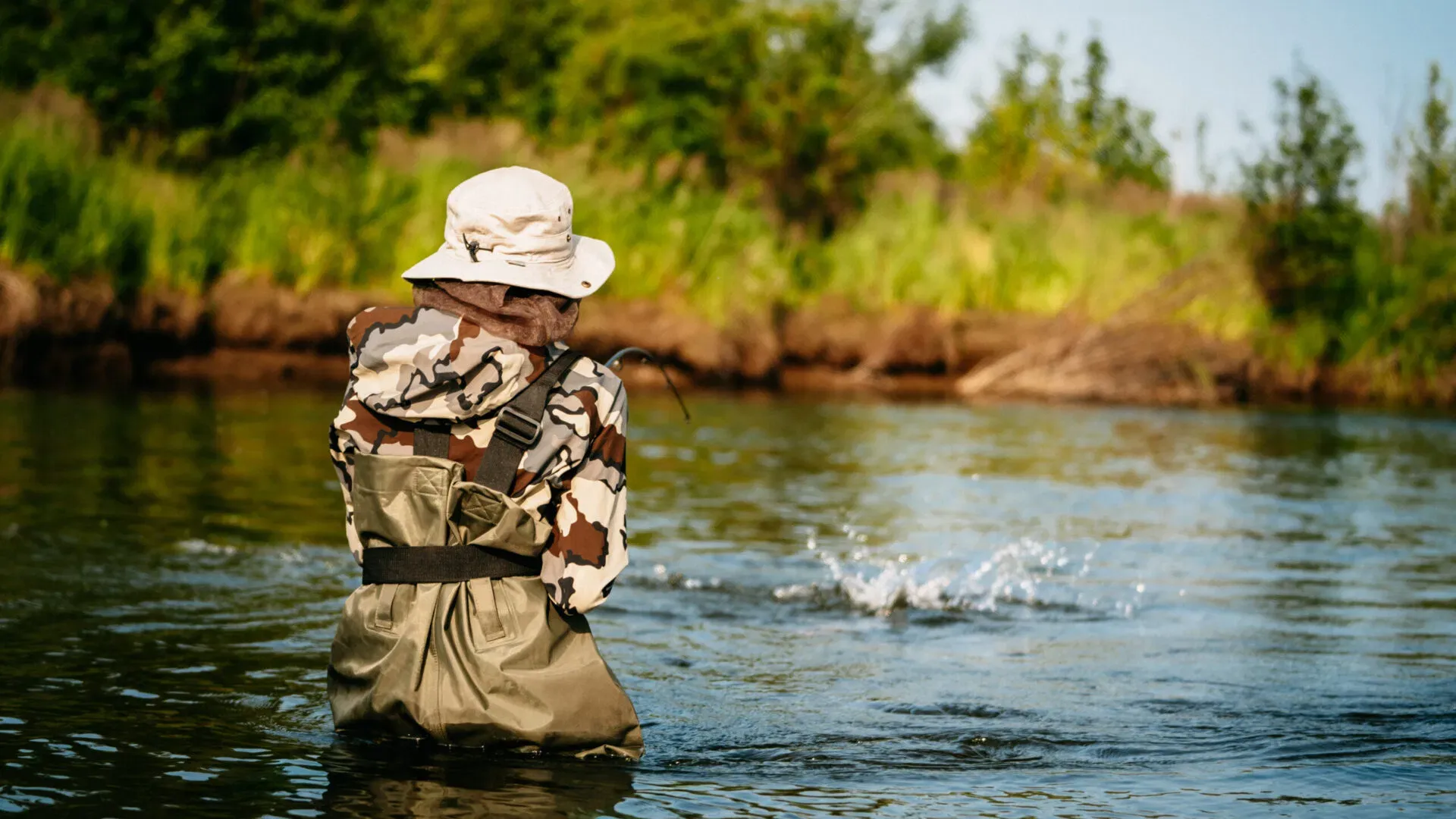 Fly-fisher casting in a remote Alaska river